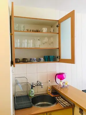 a kitchen counter with a sink and a mirror at Fresh Apartment in Sofia