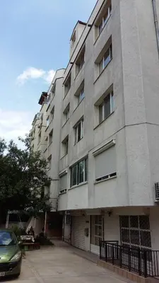 a large building with a car parked in front of it at Fresh Apartment in Sofia
