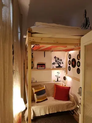 a bedroom with a bunk bed with red and yellow pillows at Pijama Hostel in Plovdiv