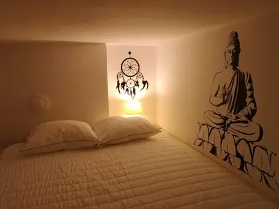 a bedroom with a bed with a clock on the wall at Pijama Hostel in Plovdiv