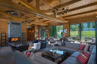 a large living room with couches and a fireplace at Cornelia Deluxe Residence in Bansko
