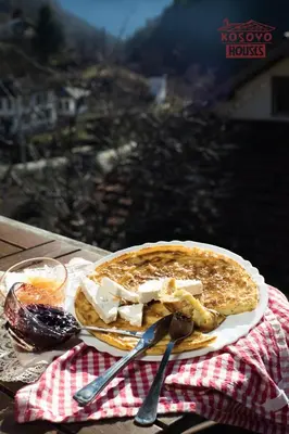 a plate of food on top of a table at Complex Kosovo Houses in Kosovo