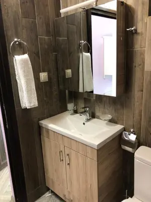 a bathroom with a sink and a mirror at Villa SUNRISE in Dospat