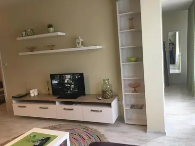 a living room with a tv on a desk at Evergreen Sofia Apartment in Sofia