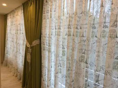 a curtain that is next to a window at Evergreen Sofia Apartment in Sofia