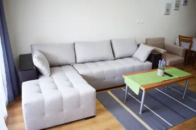 a living room with a white couch and a table at New Inn in Bansko