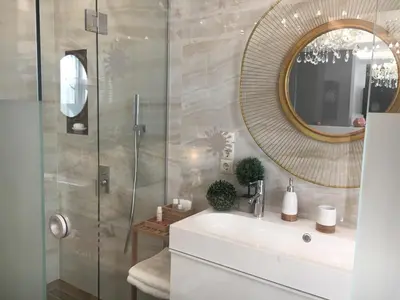 a bathroom with a sink and a mirror at Parliament Sofia - Top Center Luxury Apartment in Sofia