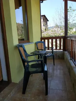 two chairs and a table on a porch at 