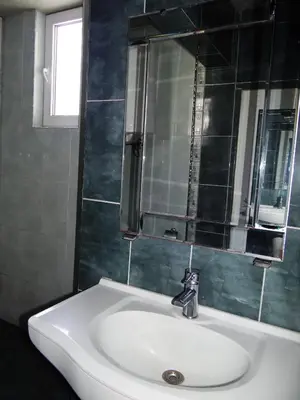 a bathroom with a white sink and a mirror at Guest Rooms Kom in Sofia