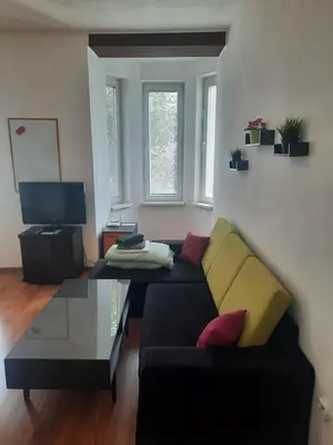 a living room with a couch and a table at Studio Cathlyn in Sofia