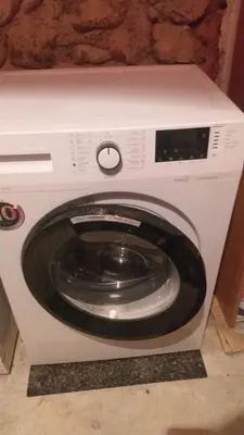 a white washing machine with its door open at Studio Cathlyn in Sofia
