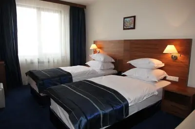 a hotel room with two beds and a window at Boutique Hotel L do Rado in Sofia