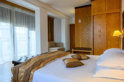 a bedroom with a large white bed with pillows at Boutique Hotel L do Rado in Sofia
