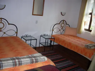 a room with two beds and two tables at Tsutsovi House in Kalofer