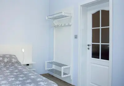 a bedroom with a bed and a door with shelves at Cozy Apartment in the very centre of Sofia in Sofia