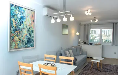 a living room with a table and a couch at Cozy Apartment in the very centre of Sofia in Sofia