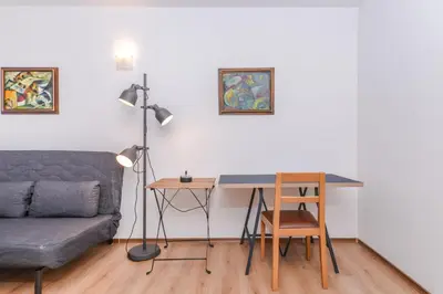 a living room with a couch and a desk at Eleganto - Central 2BD Stylish Apartment by Flat Mаnager in Sofia