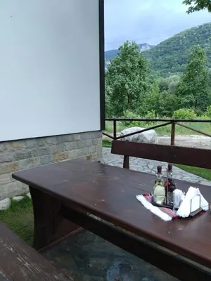 a wooden picnic table with a view of a mountain at Complex Magic of the Rhodopes in Bachkovo