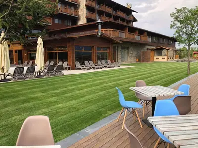 a patio with a lawn and a table and chairs at Katarino Villa Nature Escape in Razlog