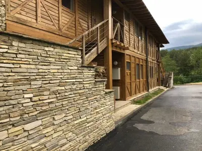 a brick building with a balcony on the side of it at Katarino Villa Nature Escape in Razlog