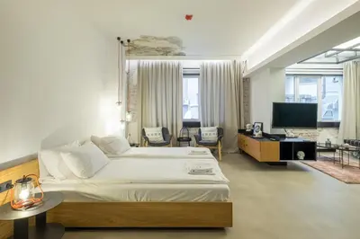 a bedroom with a large bed and a television at R34 Boutique Hotel in Sofia