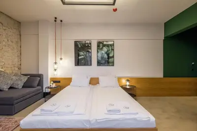 a large bed in a room with a couch at R34 Boutique Hotel in Sofia