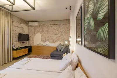 a hotel room with two beds and a couch at R34 Boutique Hotel in Sofia