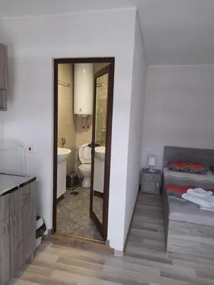 a bathroom with a toilet and a sink and a mirror at Guest Rooms IDeR in Sapareva Banya