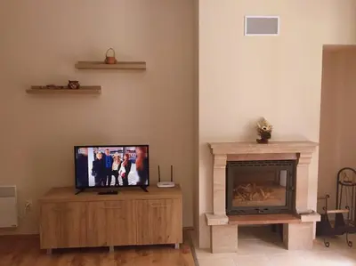 a living room with a tv and a fireplace at Northstar Ski Apartment in Mountain Lake Hotel in Pamporovo