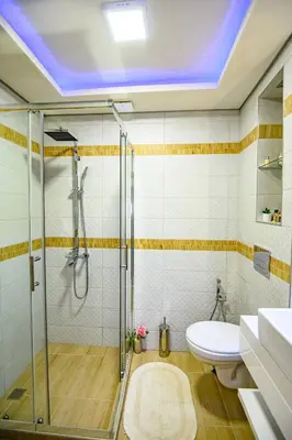 a bathroom with a shower and a toilet and a sink at Къща за гости Плевнята in Bansko