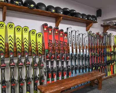 a bunch of skis are lined up against a wall at Къща за гости Плевнята in Bansko