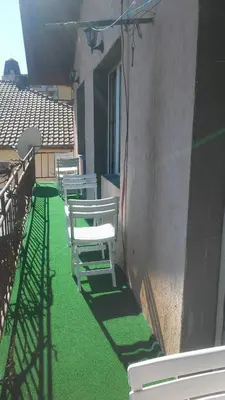 a row of white chairs sitting on the side of a building at Къща за гости Пеневи in Sofia