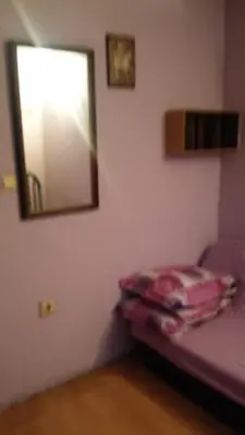 a bedroom with a mirror and a purple bed at Къща за гости Пеневи in Sofia
