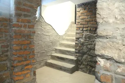 a brick stairway in a room with a brick wall at Sofia Center Cave in Sofia