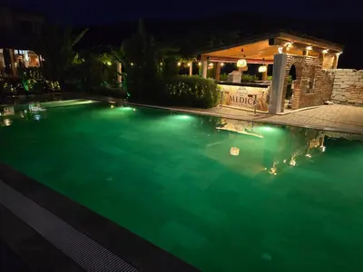 a swimming pool at night with lights in it at Boutique Hotel Colosseo in Sandanski