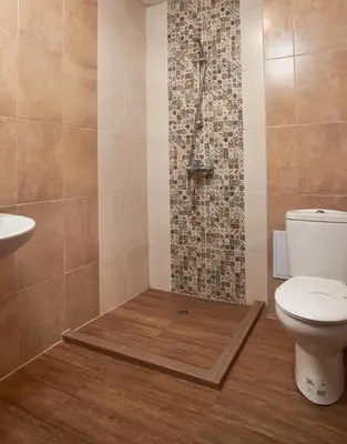 a bathroom with a shower with a toilet and a sink at Flamingo Plovdiv in Plovdiv
