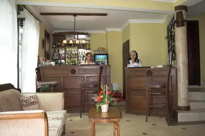 two women sitting at a bar in a room at Hotel Old Times in Asenovgrad