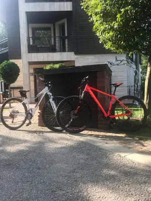 two bikes are parked next to a building at Vila 6aTo Hotel & Wellnes in Sofia