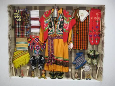 a rack of clothes and other items on a wall at Къща за гости Романс in Yagodina
