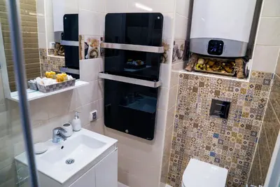 a small bathroom with a sink and a toilet at Sofia Central Luxury Apartment in Sofia