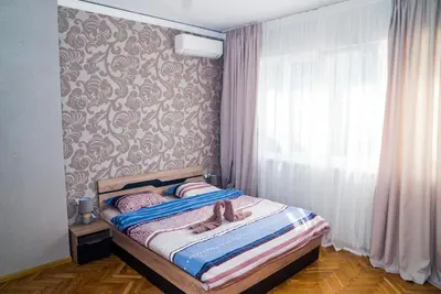 a bedroom with a bed with a doll laying on it at Sofia Central Luxury Apartment in Sofia
