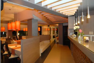 a restaurant with a bar and a dining room at Hotel Avis in Sandanski