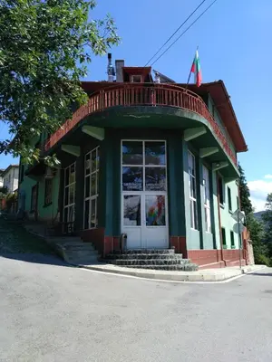 a green and white building with a porch at семеен хотел 
