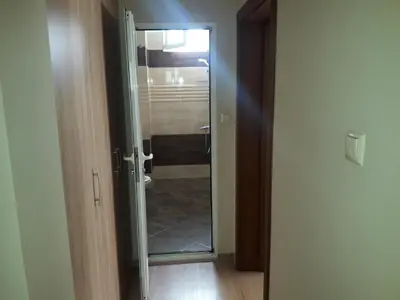 a bathroom with a glass door leading to a shower at Guest House Mania in Sofia