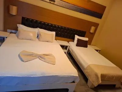 a hotel room with two beds with a bow on them at City Hotel Plovdiv FREE PARKING in Plovdiv