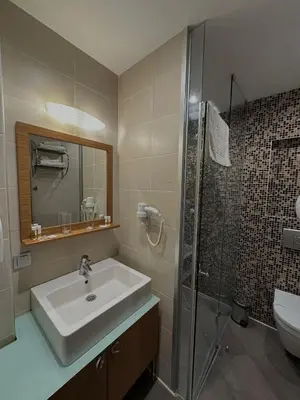 a bathroom with a sink and a shower at City Hotel Plovdiv FREE PARKING in Plovdiv