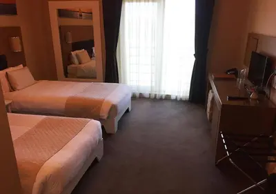 a hotel room with two beds and a television at City Hotel Plovdiv FREE PARKING in Plovdiv