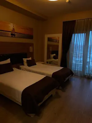 a hotel room with two beds and a mirror at City Hotel Plovdiv FREE PARKING in Plovdiv