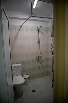 a bathroom with a toilet and a shower at Hotel Balevurov in Sandanski