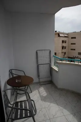 a small table and two chairs on a balcony at Hotel Balevurov in Sandanski